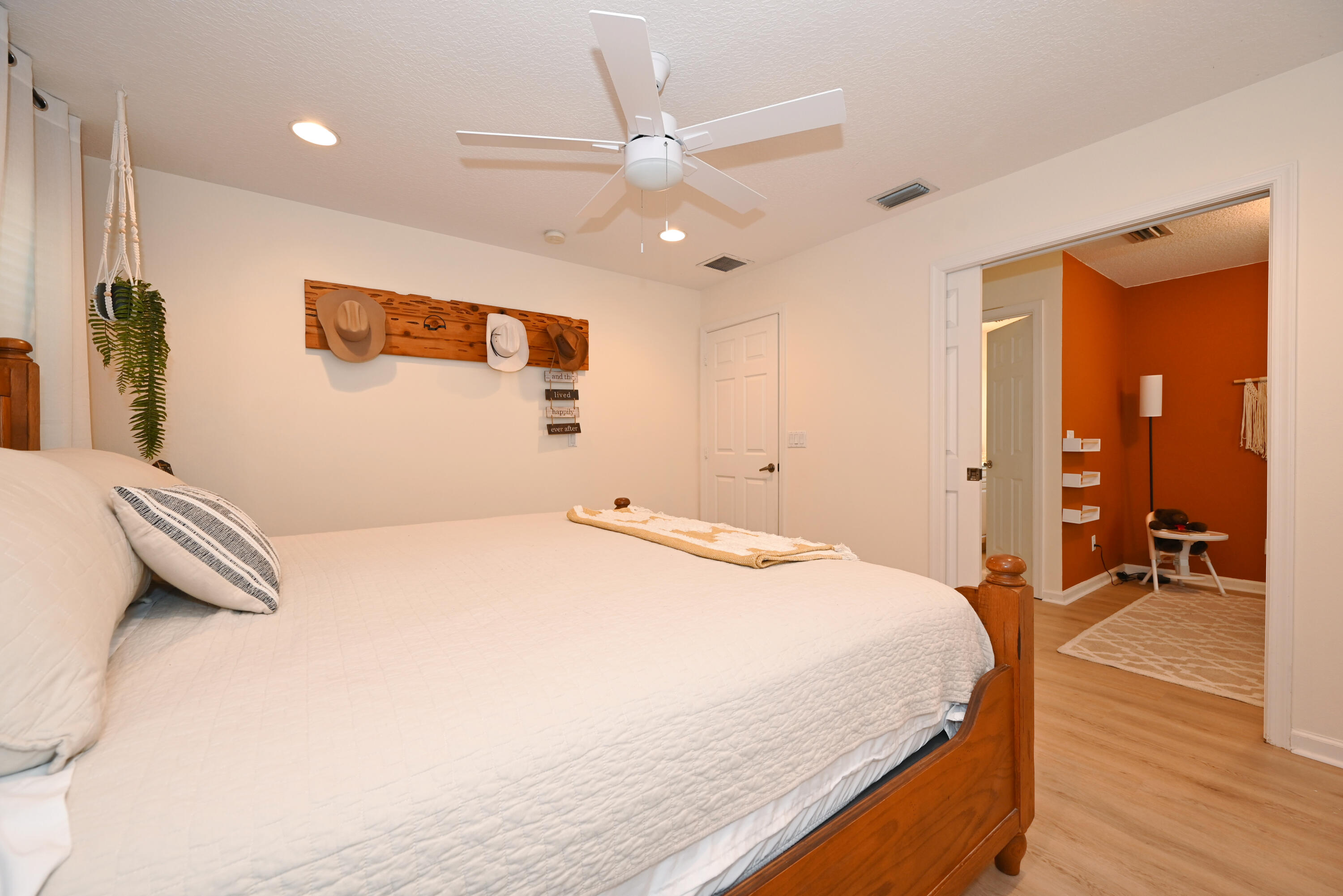 126 Faith Way Jupiter, FL 33458 - Photo 26 of 61 a bedroom with a bed and a chandelier