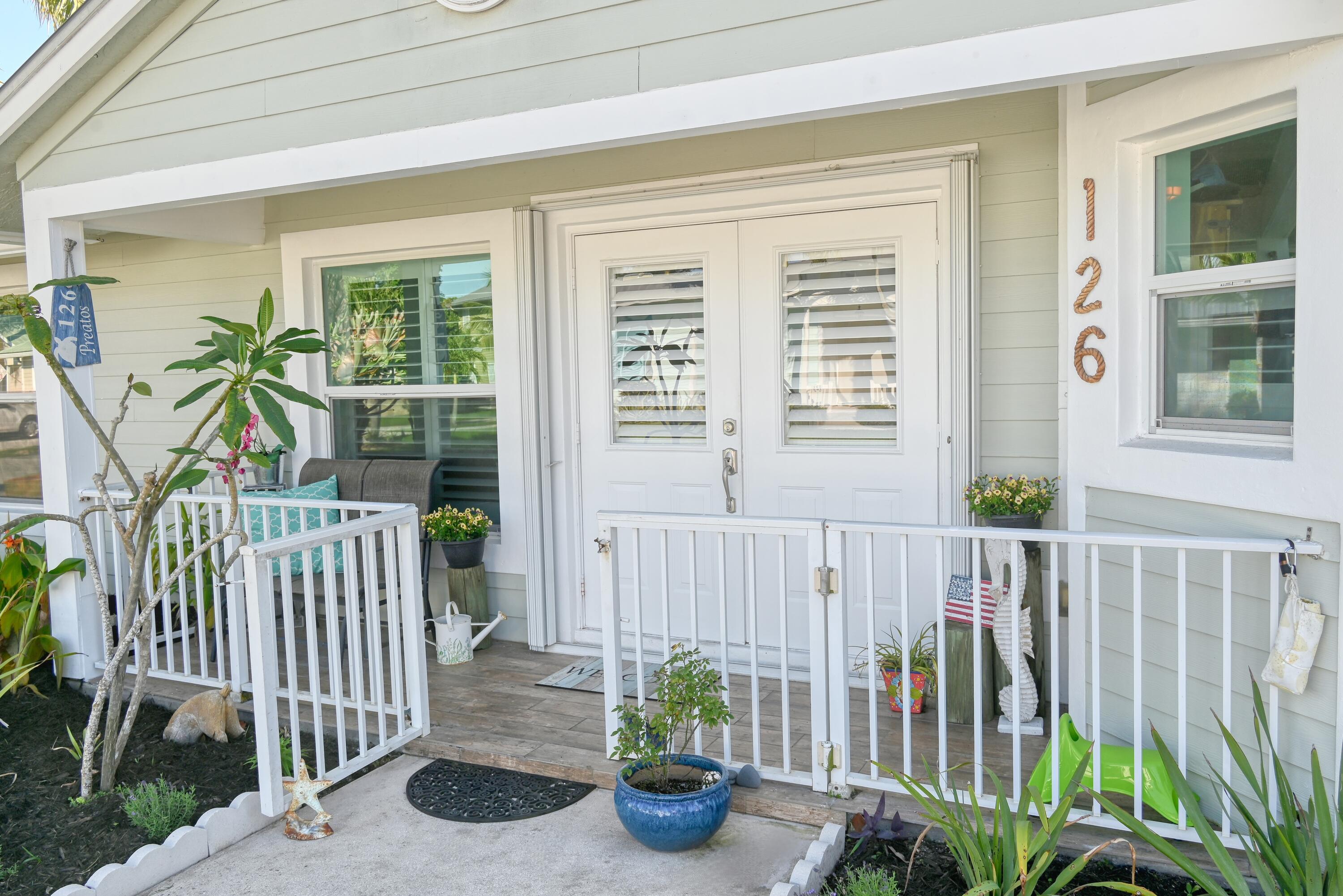 126 Faith Way Jupiter, FL 33458 - Photo 3 of 61 a view of a porch with chairs