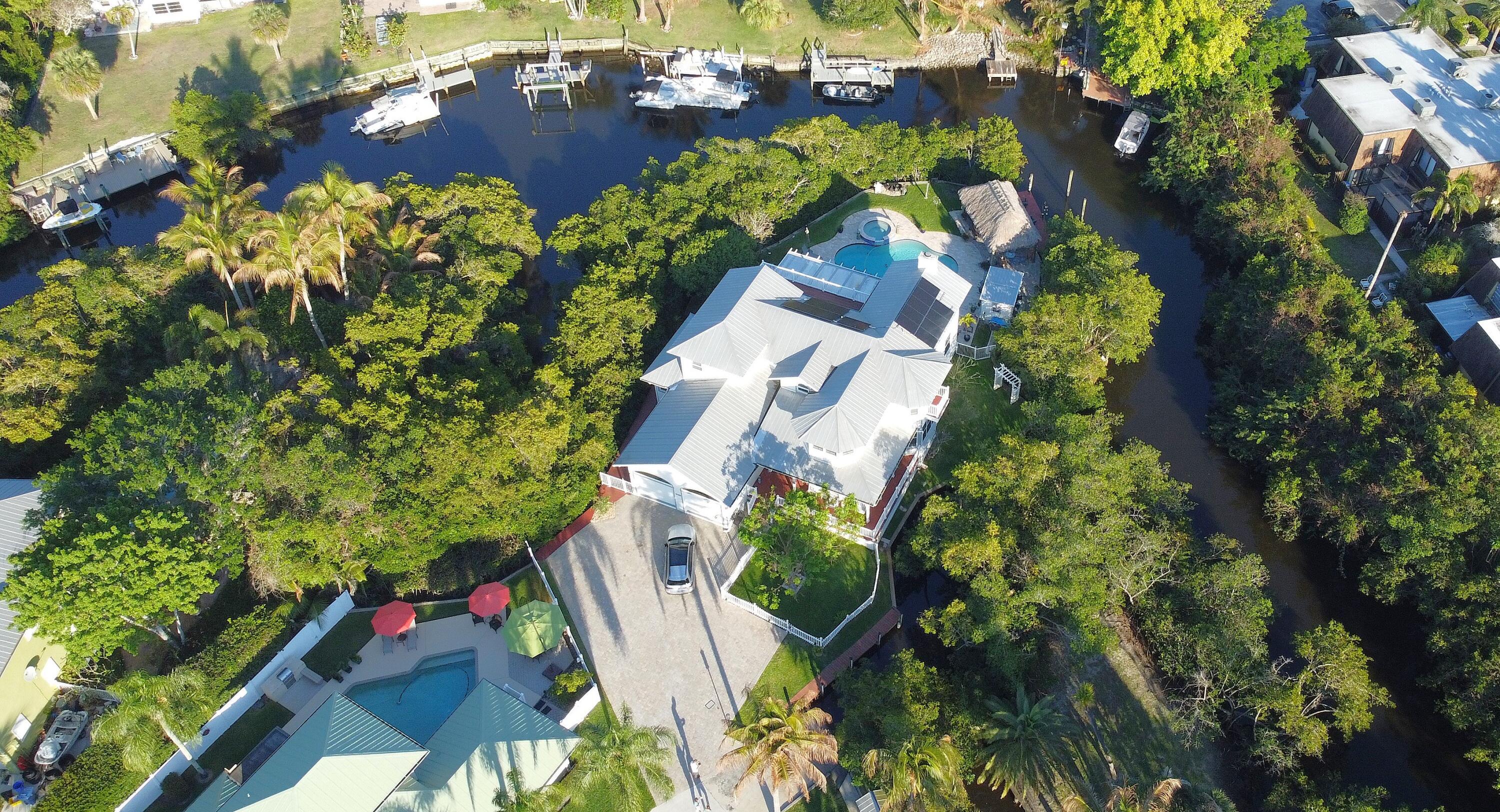 126 Faith Way Jupiter, FL 33458 - Photo 51 of 61 an aerial view of a house yard and swimming pool