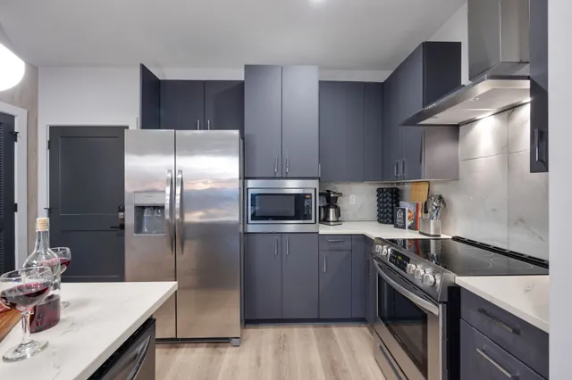 a kitchen with a sink refrigerator and microwave