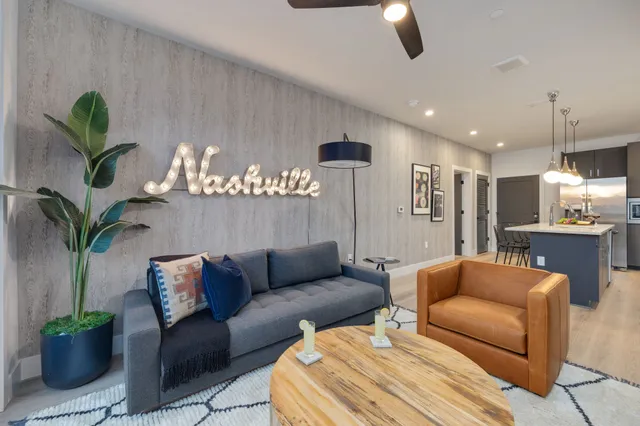 a living room with furniture flowerpot and a chandelier