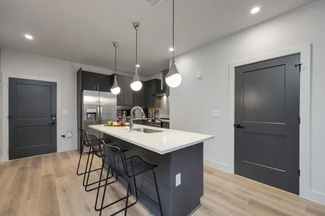 a large kitchen with a table and chairs