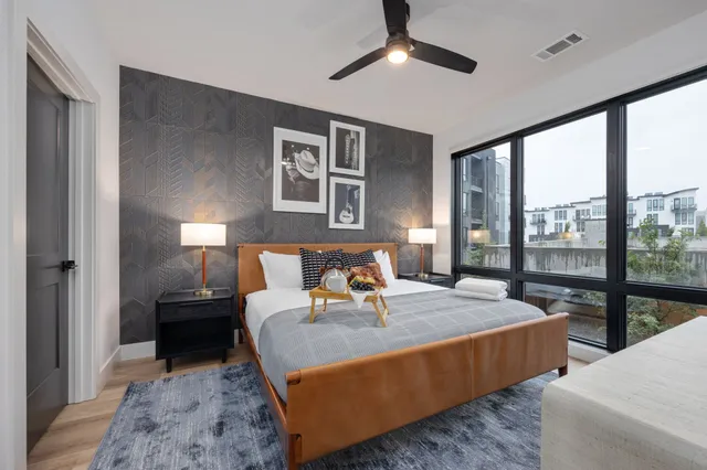 a bedroom with a large bed and a large window