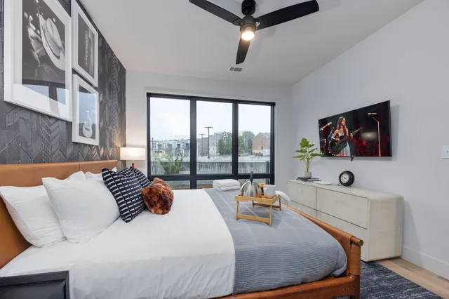 a bedroom with a large bed and a flat screen tv