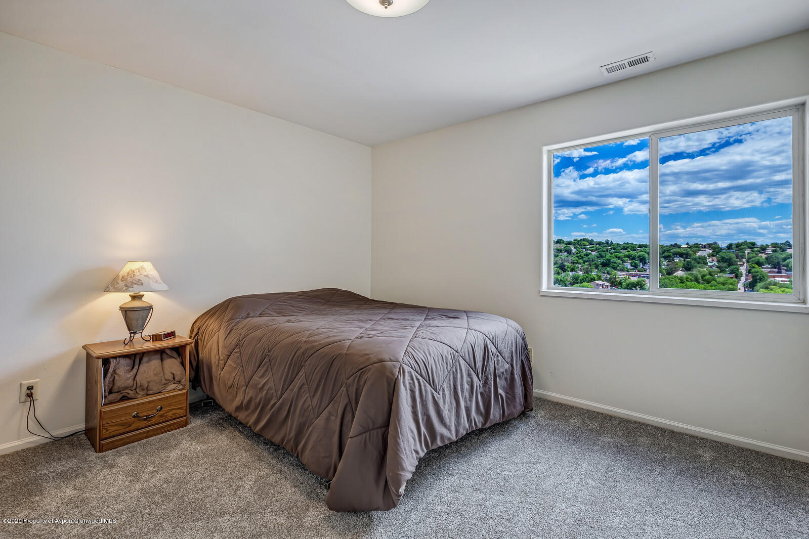 426 Lind Avenue Rifle, CO 81650 - Photo 14 of 20 a spacious bedroom with a bed and a window