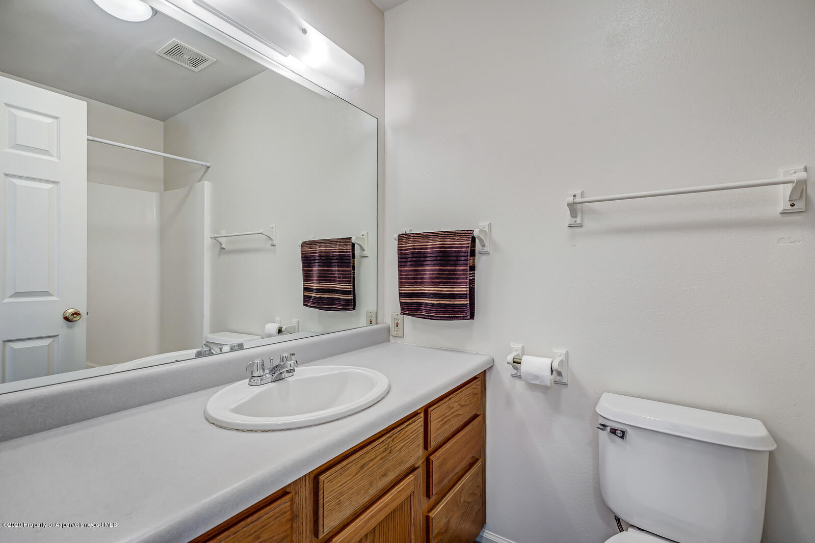 426 Lind Avenue Rifle, CO 81650 - Photo 17 of 20 a bathroom with a double vanity sink toilet and a mirror
