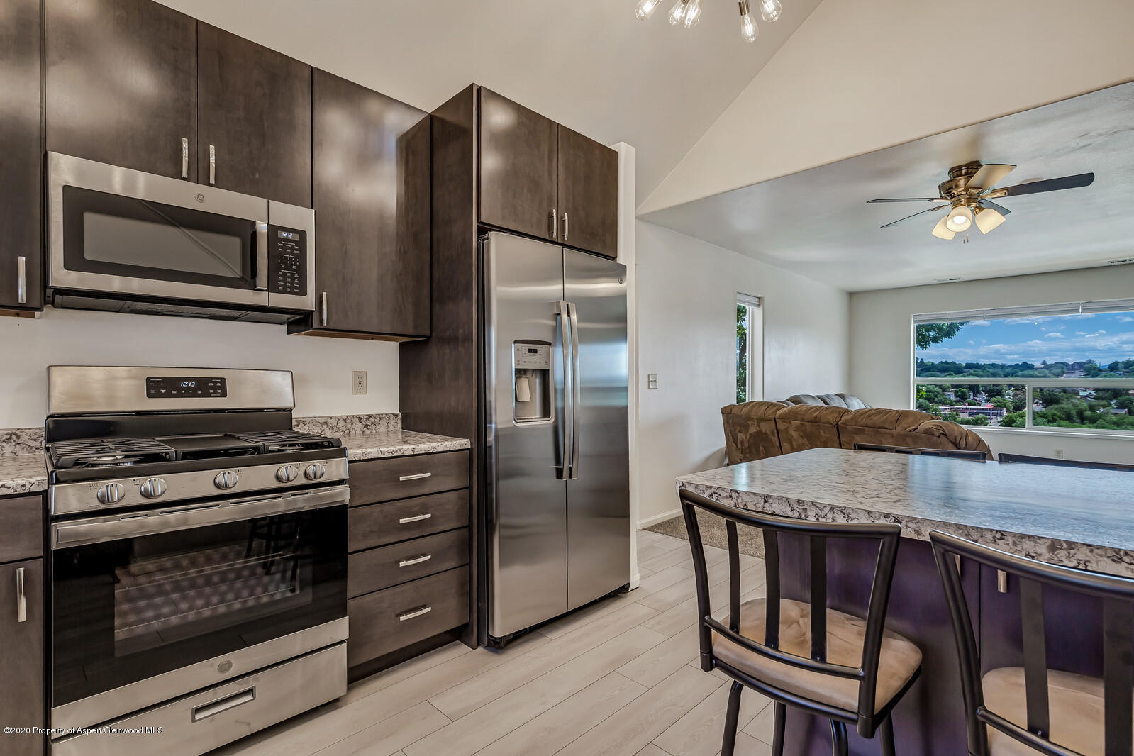 426 Lind Avenue Rifle, CO 81650 - Photo 4 of 20 a kitchen with a stove a refrigerator and a microwave