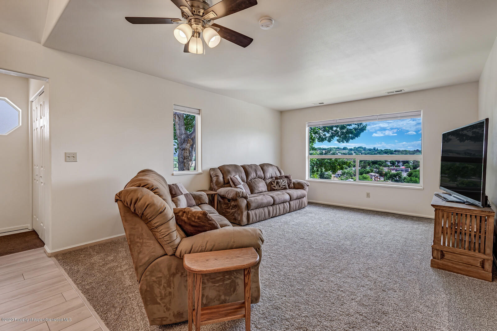 426 Lind Avenue Rifle, CO 81650 - Photo 5 of 20 a living room with furniture a flat screen tv and a window