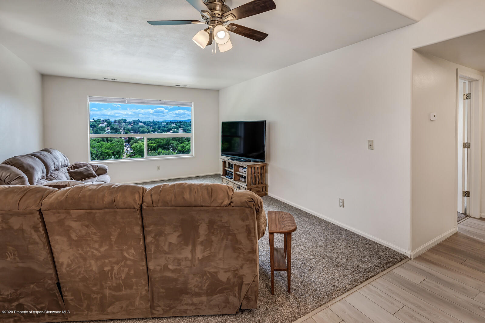 426 Lind Avenue Rifle, CO 81650 - Photo 6 of 20 a living room with furniture and a flat screen tv