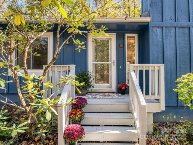 a front view of a house with a fountain
