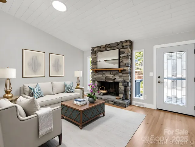 a living room with furniture and a fireplace