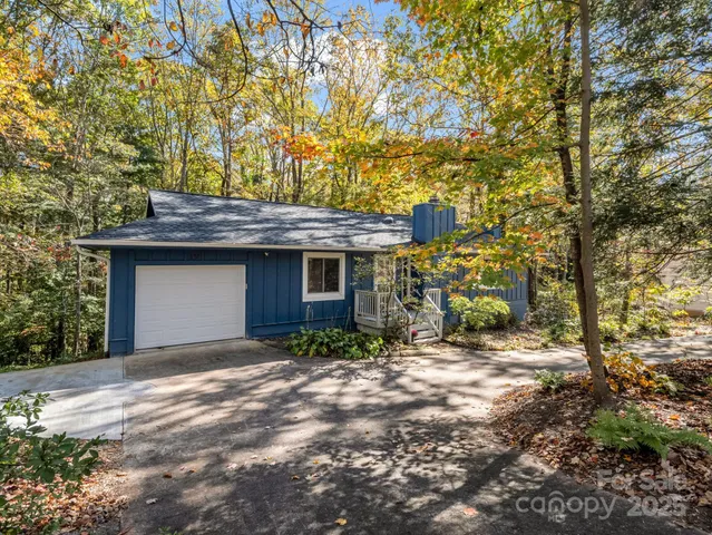 a view of a house with a yard and garage