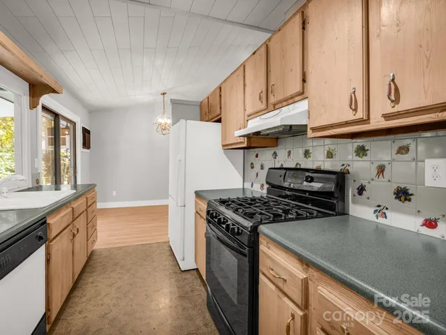 a kitchen with stainless steel appliances granite countertop a stove and a sink