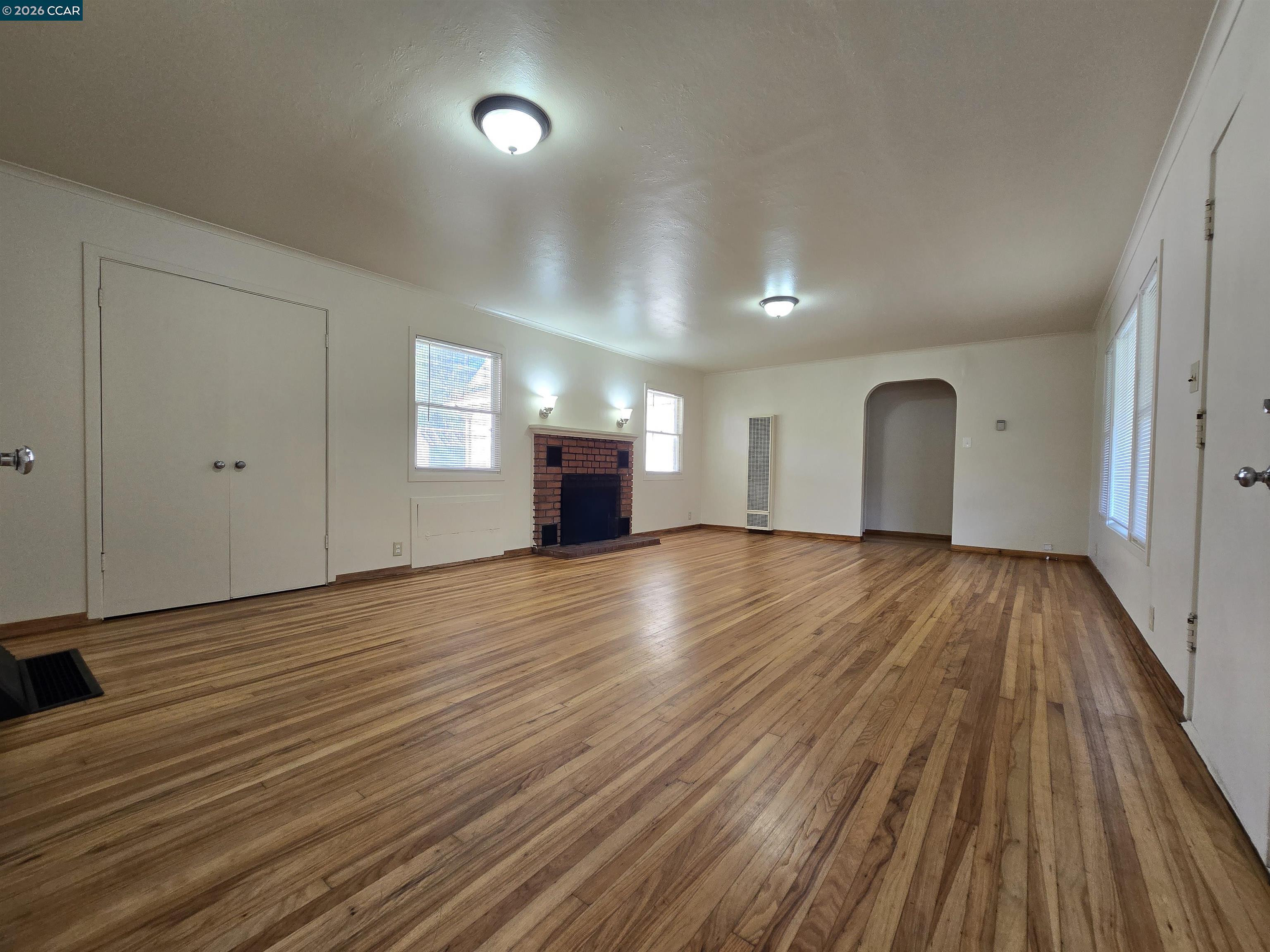 4455 Appian Way El Sobrante, CA 94803 - Photo 2 of 12 a view of a room with wooden floor and window