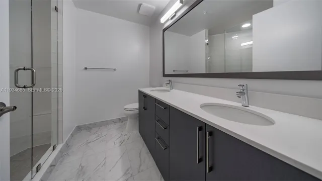 a bathroom with a double vanity sink a and a mirror