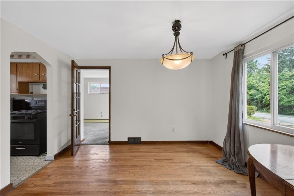 1420 Homestead Road Verona, PA 15147 - Photo 8 of 34 a view of empty room with wooden floor and fan