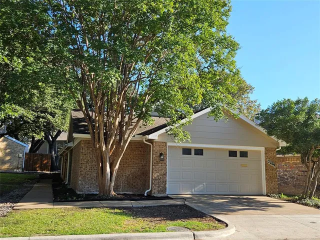 a front view of house with yard and trees
