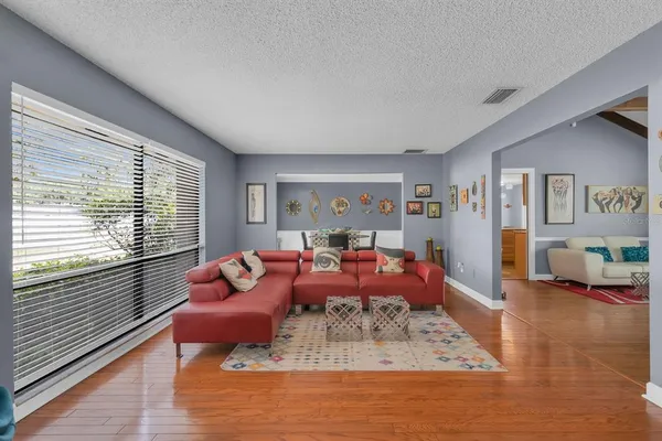 a living room with furniture or couch and a large window