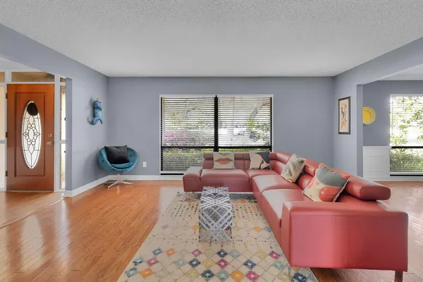 a living room with furniture large window and lamp