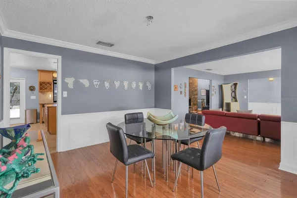 a dining room with furniture and wooden floor
