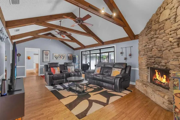 a view of a dining room with furniture wooden floor and chandelier