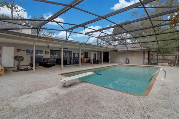 a view of a house with a backyard porch and sitting area