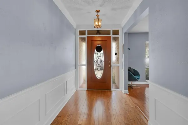 wooden floor in a hall with a window