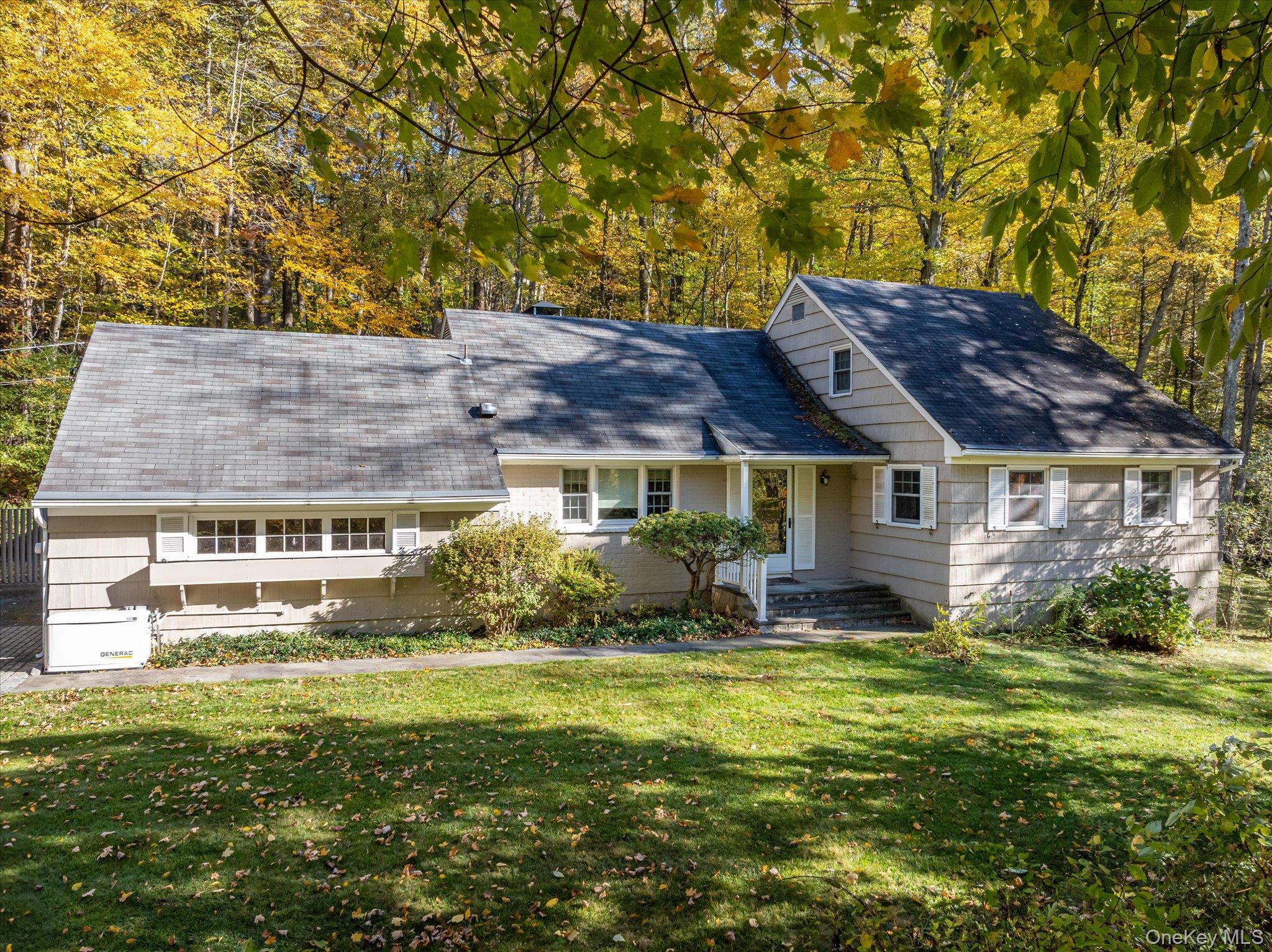 a view of house with yard and outdoor seating