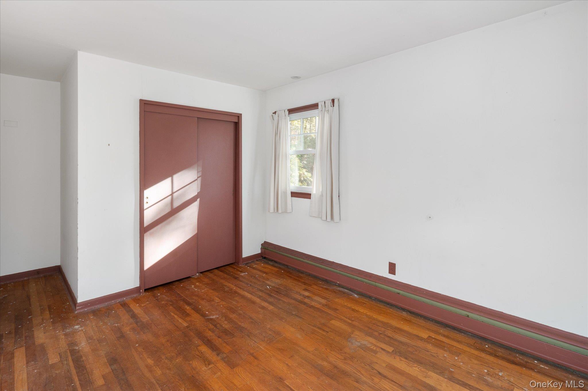 131 Allison Road Katonah, NY 10536 - Photo 20 of 28 a view of an empty room with wooden floor and a window
