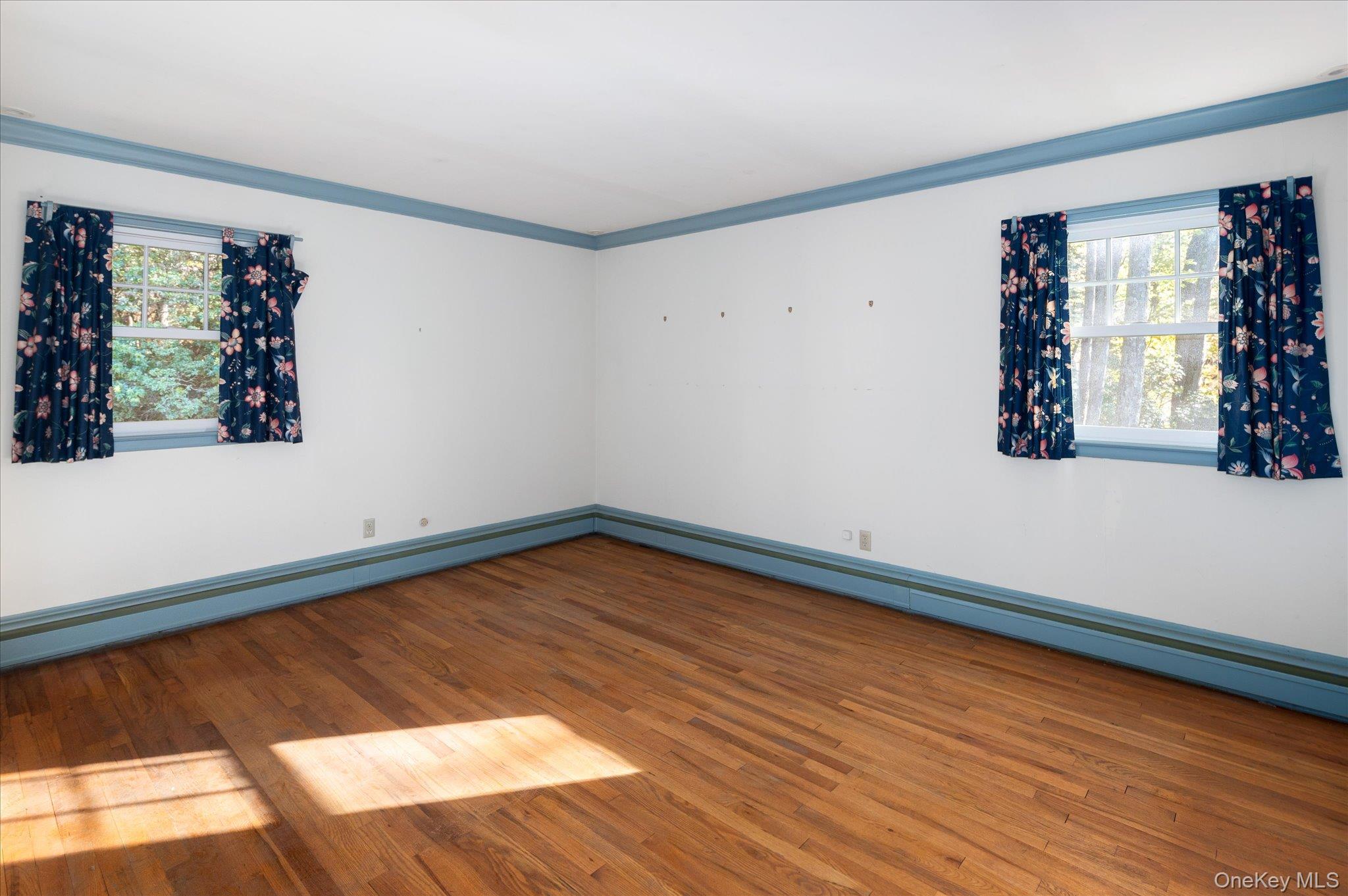 131 Allison Road Katonah, NY 10536 - Photo 21 of 28 a view of an empty room with window and wooden floor