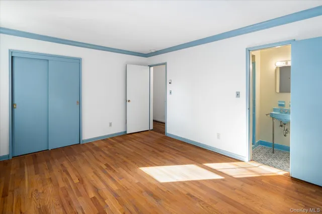 a view of an empty room and wooden floor