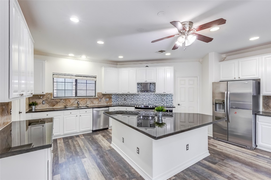 2310 McKendrick Drive Cedar Park, TX 78613 - Photo 12 of 32 a kitchen with granite countertop a sink stainless steel appliances and window