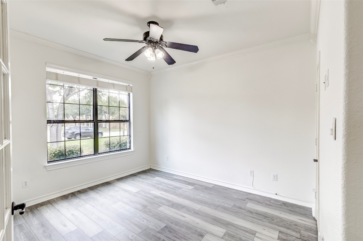 2310 McKendrick Drive Cedar Park, TX 78613 - Photo 15 of 32 a view of empty room with wooden floor and fan