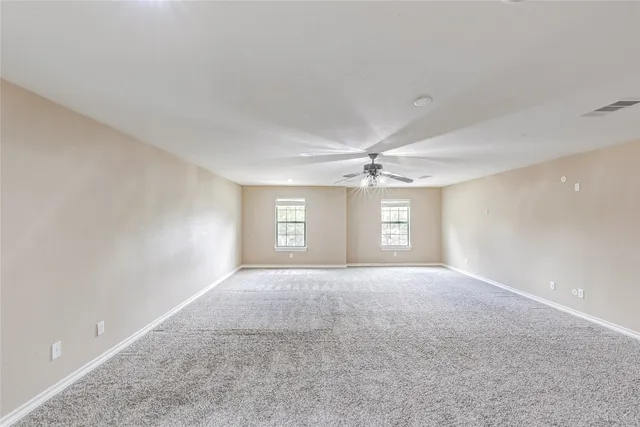 a view of a big room with windows and cabinet