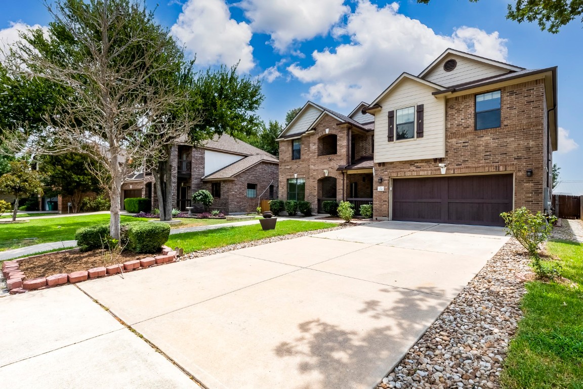 2310 McKendrick Drive Cedar Park, TX 78613 - Photo 2 of 32 a front view of a house with a yard and garage