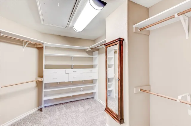 a view of walk in closet with empty racks