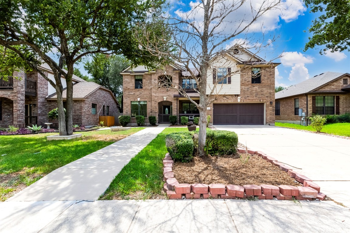 2310 McKendrick Drive Cedar Park, TX 78613 - Photo 3 of 32 a front view of a house with garden