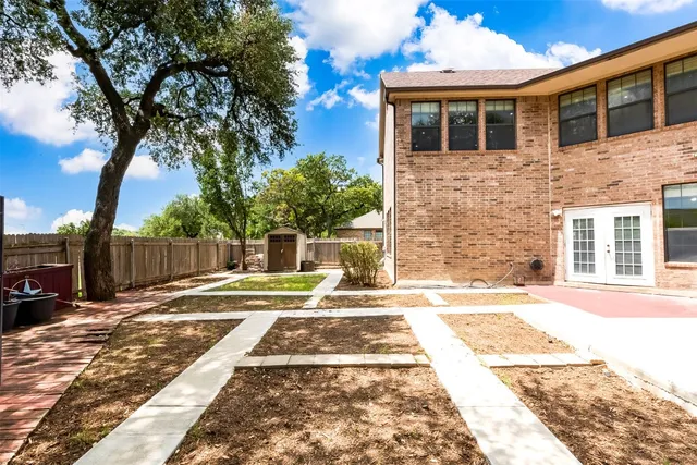 a backyard of a house with table and chairs