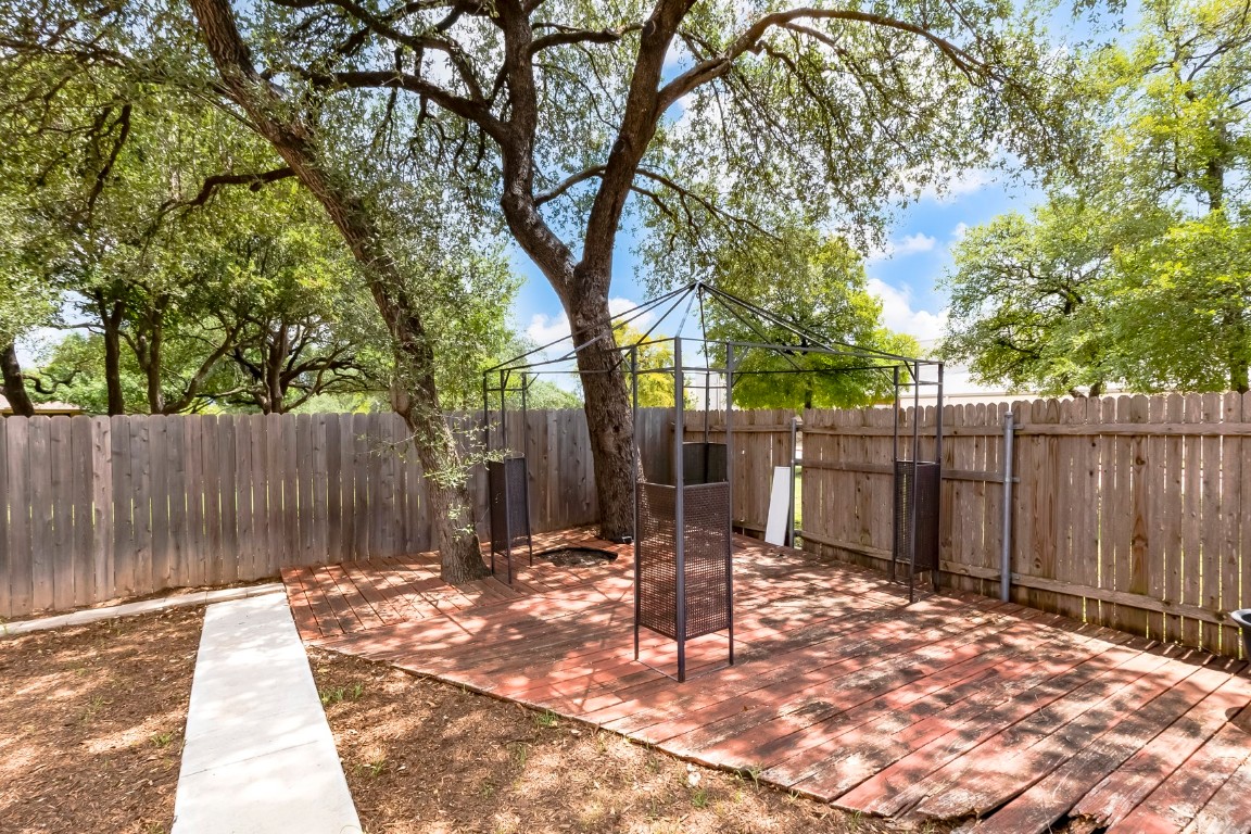 2310 McKendrick Drive Cedar Park, TX 78613 - Photo 31 of 32 a backyard of a house with table and chairs