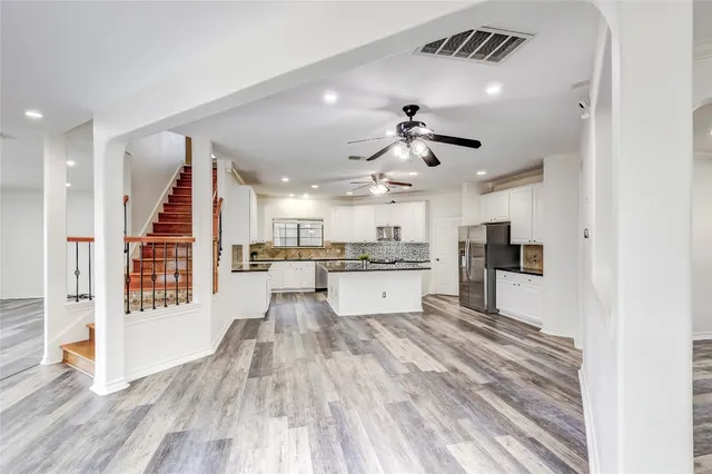 a kitchen with stainless steel appliances granite countertop a stove a refrigerator and a sink