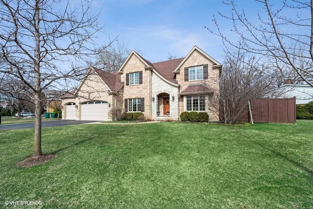 Undisclosed Address Deerfield, IL 60015 - Photo 1 of 34 a view of a yard in front of a house with large tree