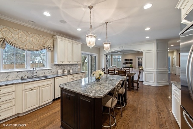 Undisclosed Address Deerfield, IL 60015 - Photo 12 of 34 a kitchen with center island table and chairs in it