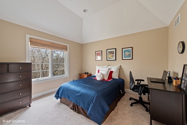 Undisclosed Address Deerfield, IL 60015 - Photo 17 of 34 a bed room with a bed window and a desk