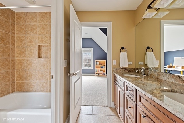 Undisclosed Address Deerfield, IL 60015 - Photo 21 of 34 a bathroom with a granite countertop sink tub and a mirror