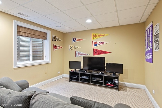 Undisclosed Address Deerfield, IL 60015 - Photo 26 of 34 a living room with furniture and a flat screen tv