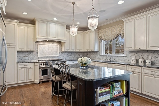 Undisclosed Address Deerfield, IL 60015 - Photo 4 of 34 a kitchen with kitchen island granite countertop a sink cabinets and stainless steel appliances