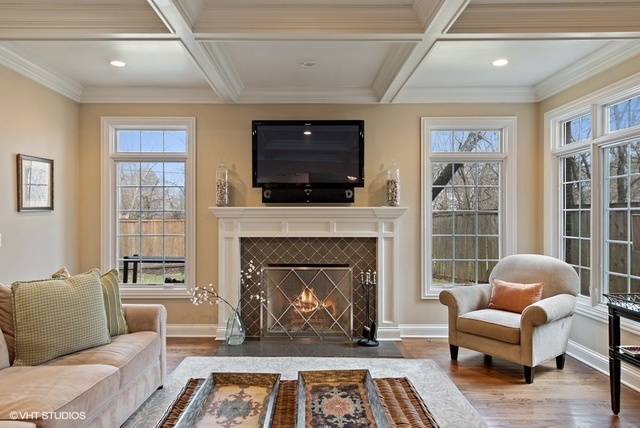Undisclosed Address Deerfield, IL 60015 - Photo 9 of 34 a living room with furniture a flat screen tv and a fireplace
