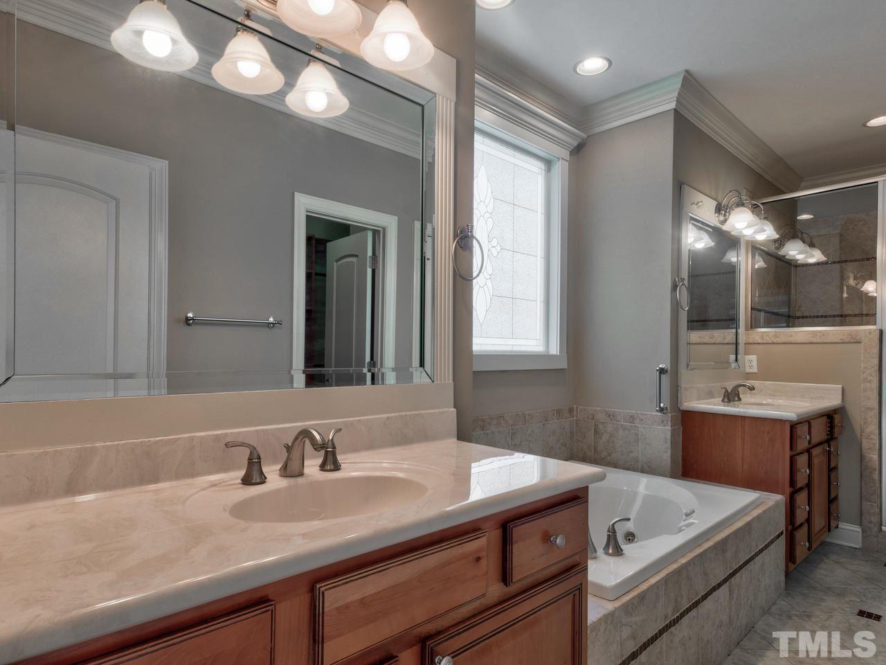 100 Cyprine Court Raleigh, NC 27603 - Photo 14 of 30 a bathroom with a sink and a mirror