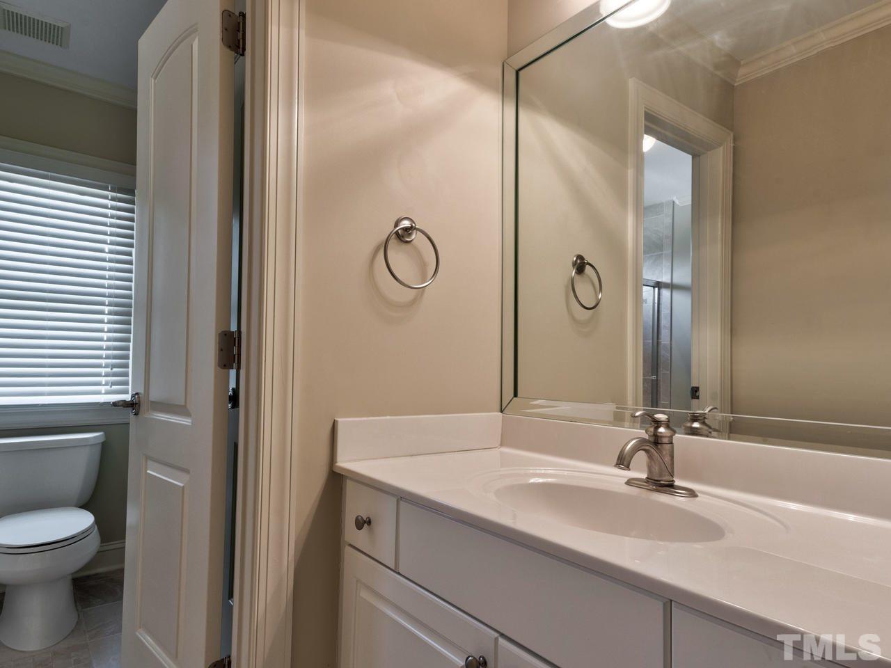 100 Cyprine Court Raleigh, NC 27603 - Photo 22 of 30 a bathroom with a sink and a mirror