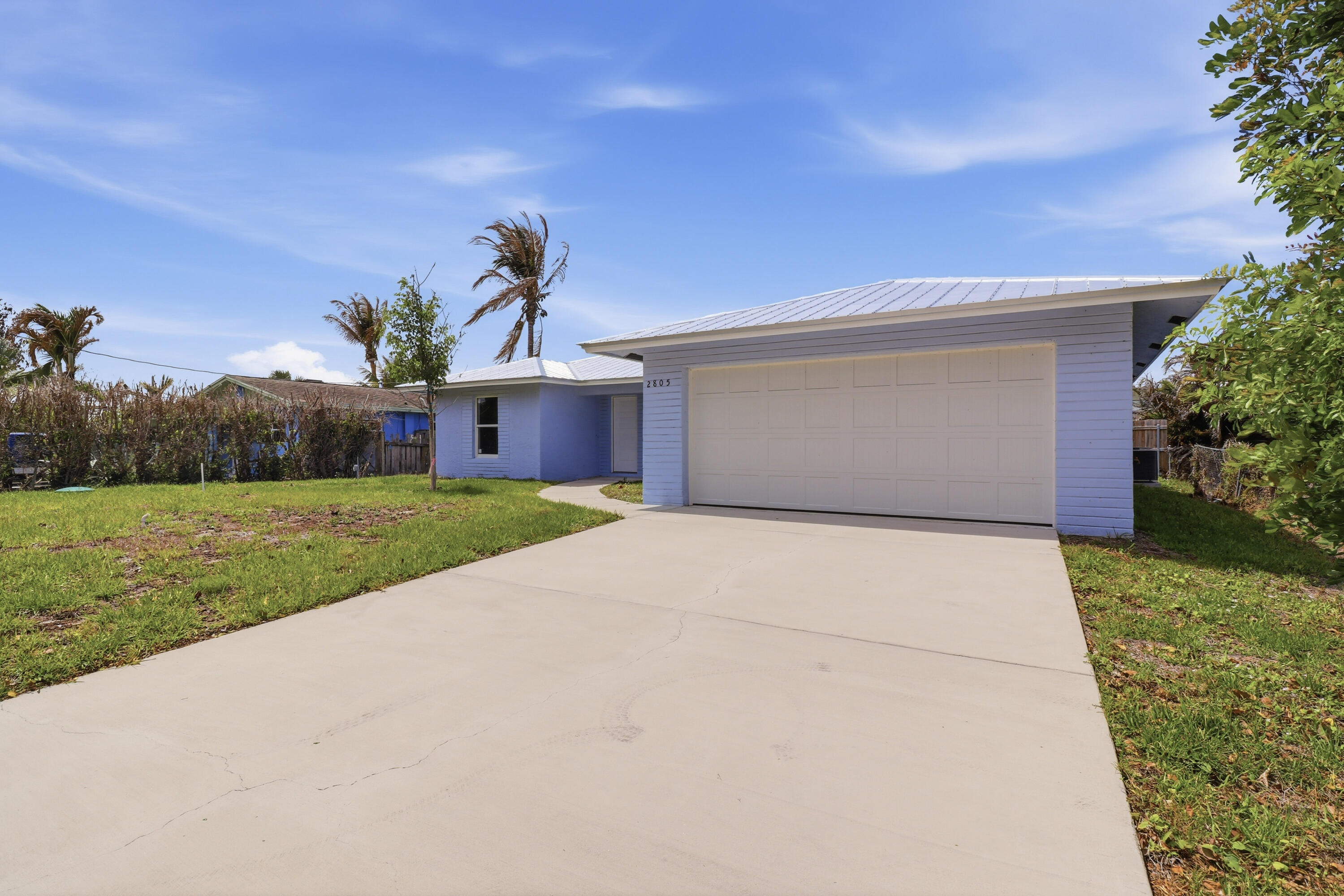 2805 Southeast Carroll Street Stuart, FL 34997 - Photo 20 of 21 a front view of house with yard and green space